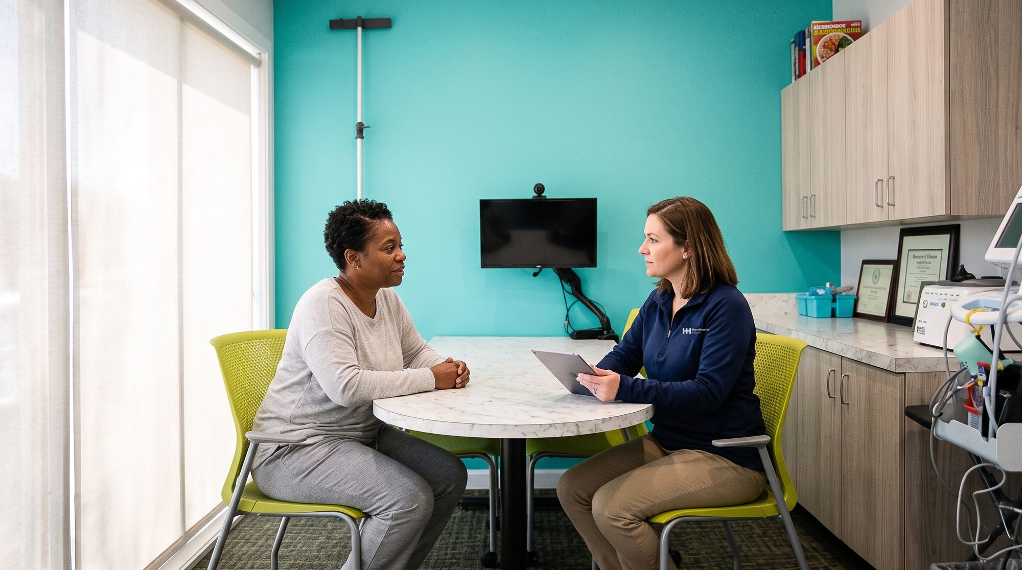 Private consultation between a patient and a research coordinator in the pharmacy consultation room