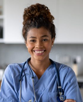 Portrait of an African American female doctor making a house call visit - healthcare and medicine concepts